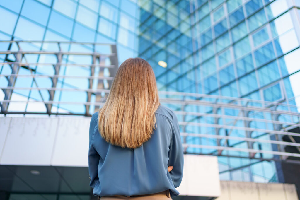 back view woman looking business building